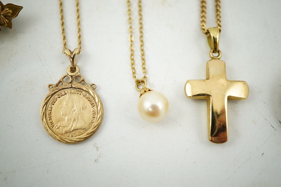 A collection of jewels, comprising: two cross pendants; a heart-shaped locket pendant; a circular locket pendant engraved with a sunflower; a pendant set with a sapphire; a diamond panel brooch; and a sapphire and diamon